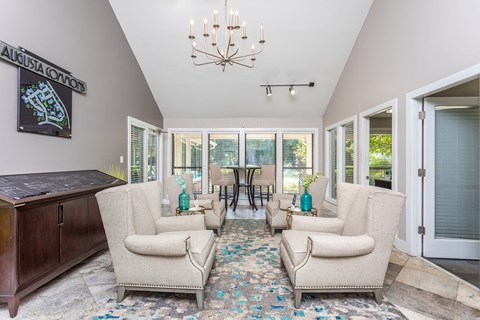 a living room with couches and chairs and a chandelier